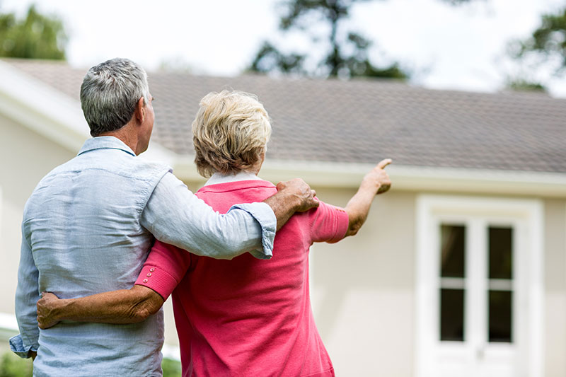 the shingle master couple looking at roof